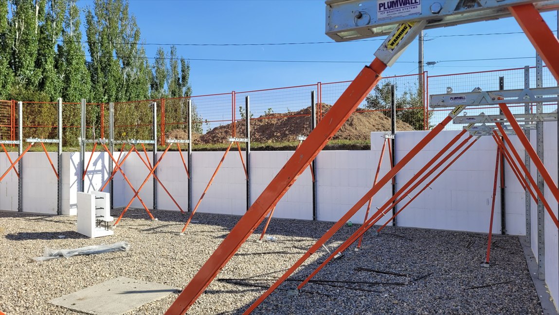 An ICF basement wall stacked, squared and held on Plumwall alignment bracing, ready for the pour